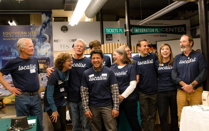 People standing in a row wearing shirts that read "localist".