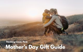 A woman outside giving a child a hug.