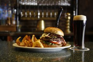 Carver Brewing Company A photograph featuring a burger and beer on a counter.